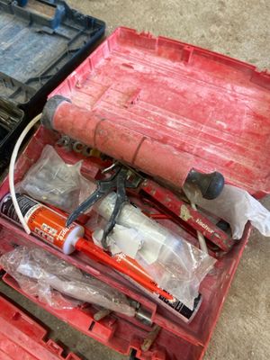 a red tool case with tools in it on the floor