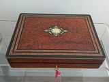 a small wooden box with a decorative decoration on it
