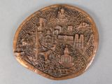 an image of a bronze coin with a picture of a city