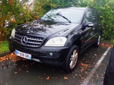 a black mercedes mlx parked in a parking lot