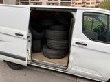 a white van with a bunch of tires in the back