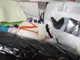 a pile of clothes and other items in a plastic bag