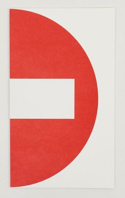 a red and white no entry sign on a white wall
