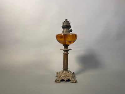 a glass lamp that is sitting on a table