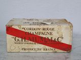 a box of champagne on a table with a red ribbon around it