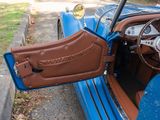 a close up of a blue car with a brown leather seat