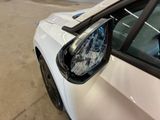 a white car with a broken window and a broken mirror