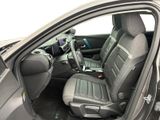 the interior of a car with the door open showing the driver ' s seat area