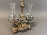 two glass vases on a stand on a table