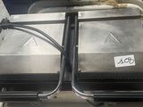 two metal trays on top of a cart