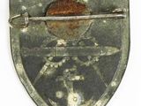 an image of a metal badge with an arrow on it