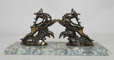 pair of antique bronze figurines of lions on marble bases