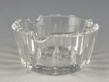 a clear glass bowl on a table with a gray background