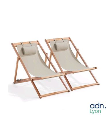 pair of wooden and canvas lounge chairs on a white background