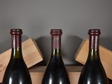 three bottles of wine sitting on a table next to a wooden box