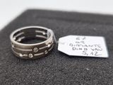 a silver ring and a tag on a black cloth