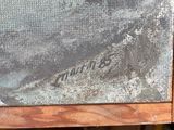 a picture of a painting on a table with a teddy bear next to it