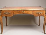 an antique wooden desk with two drawers and a brass plate top