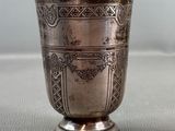 a silver cup that is sitting on a table