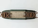 an overhead view of a model of a wooden boat on a white surface