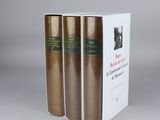 three books are stacked on top of each other on a table