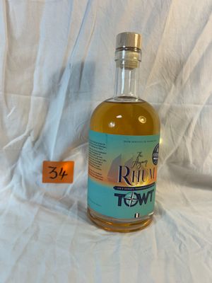 a bottle of rum that is sitting on a white sheet