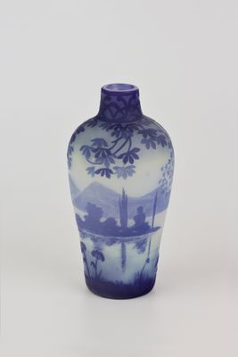 un vase bleu et blanc posé sur une surface blanche