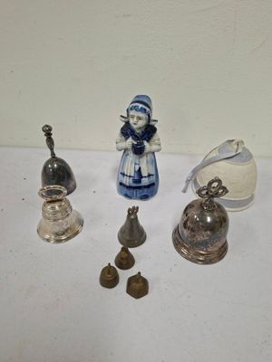 a small collection of bells and figurines on a table