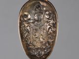 a silver pendant with a coat of arms on it