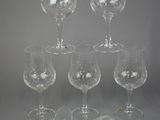 several empty wine glasses and a bottle of wine on a table