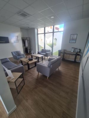 an image of a living room with couches and chairs