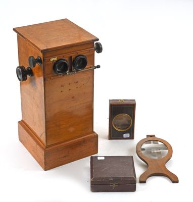 a small wooden box with a magnifying glass on top of it