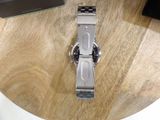 a watch sitting on a wooden table on a table