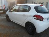 a picture of a white car parked in front of a building