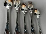 five forks and spoons sitting on a table