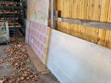 a pile of wood in a shed with a sheet of plastic