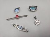 four different pieces of jewelry on a table