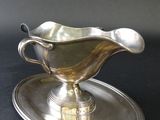 an antique silver plate with a saucer and saucer on it