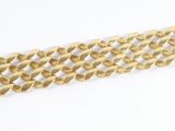 a close up of a gold chain on a white surface