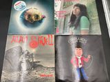 three album covers of a woman and a man on a table