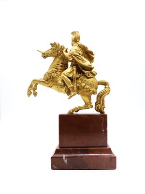bronze statue of a man on a horse on a marble base