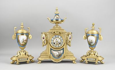 three gold and blue vases and a clock on a table