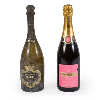two bottles of champagne sitting next to each other on a white surface