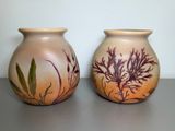 two vases that are sitting on a table