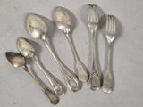 six silver spoons and a fork on a white surface