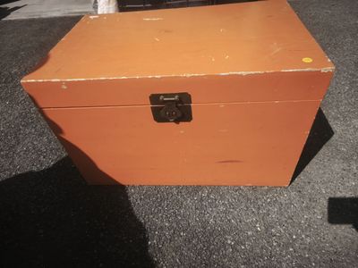 an orange box that is sitting on the ground