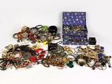 a lot of jewelry sitting on a white surface