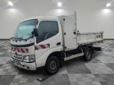 a white truck that is sitting on a checkered floor