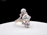 une photo d'une bague en diamant et en or posée sur une assiette blanche