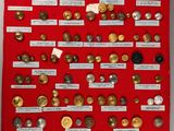 a close up of a display of buttons on a red cloth